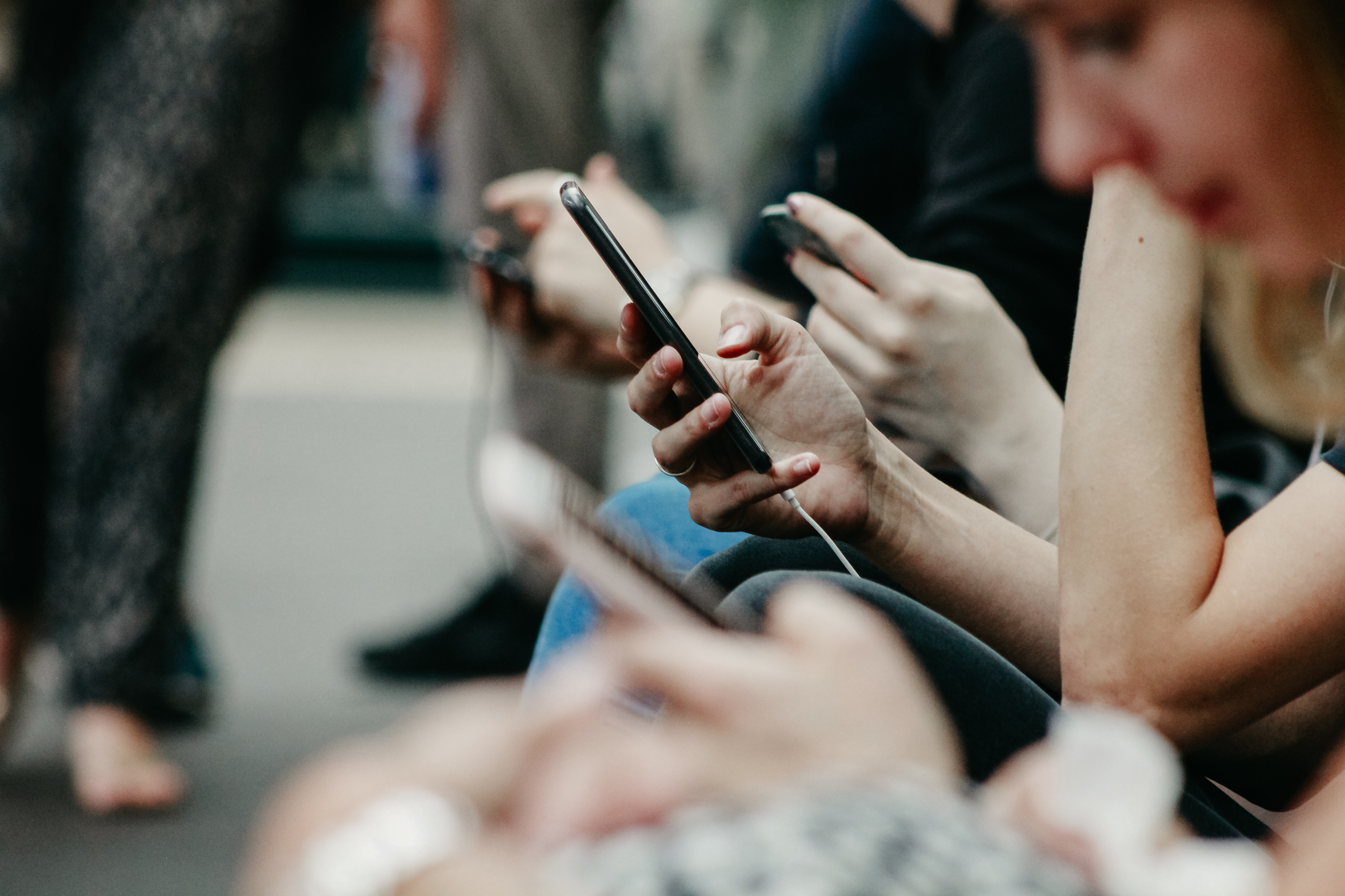 Abstract image of people looking at their phones